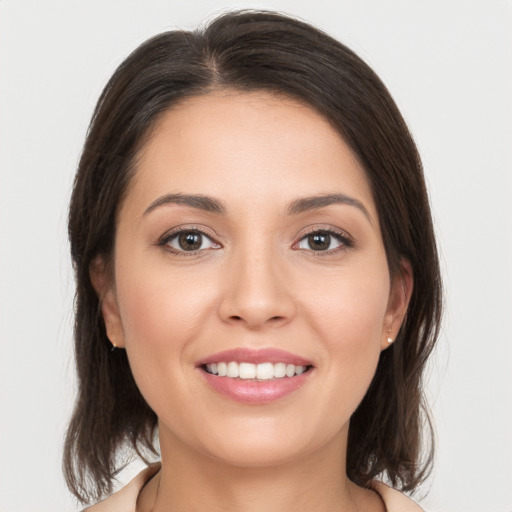 Joyful white young-adult female with medium  brown hair and brown eyes