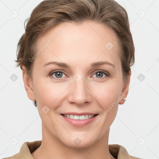 Joyful white young-adult female with short  brown hair and grey eyes