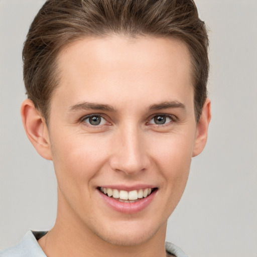 Joyful white young-adult female with short  brown hair and grey eyes