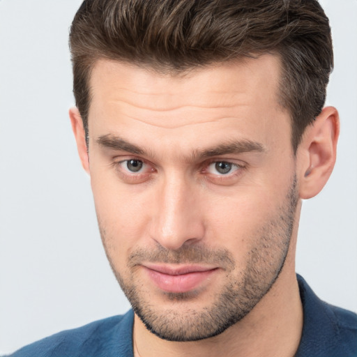 Joyful white young-adult male with short  brown hair and brown eyes