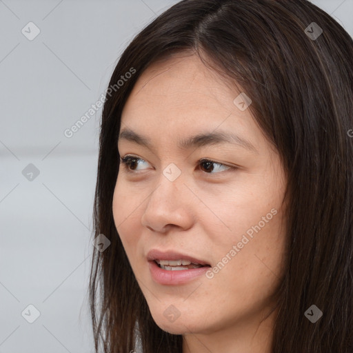 Joyful asian young-adult female with long  brown hair and brown eyes