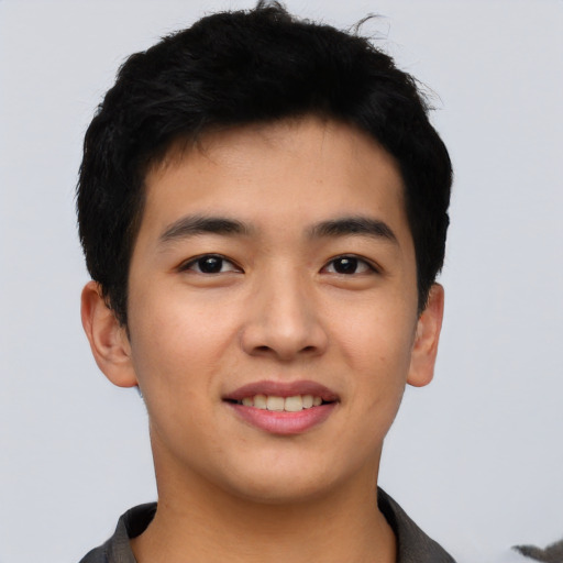Joyful asian young-adult male with short  black hair and brown eyes