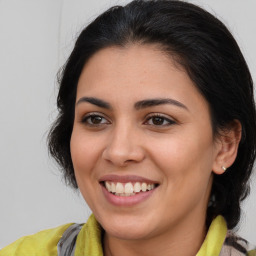 Joyful latino young-adult female with medium  brown hair and brown eyes