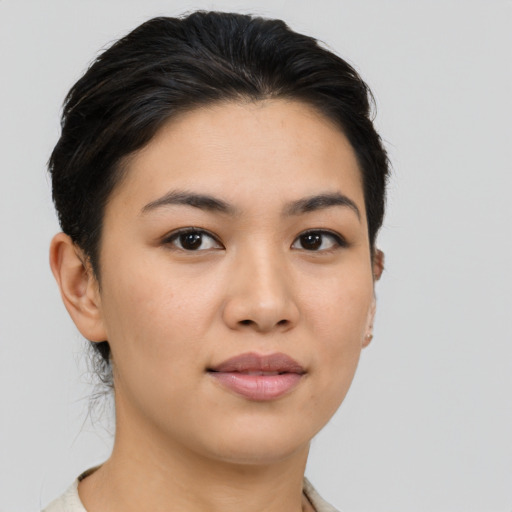 Joyful latino young-adult female with medium  brown hair and brown eyes