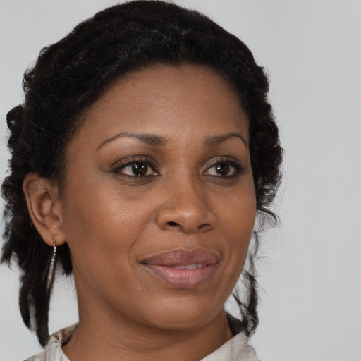 Joyful black adult female with medium  brown hair and brown eyes