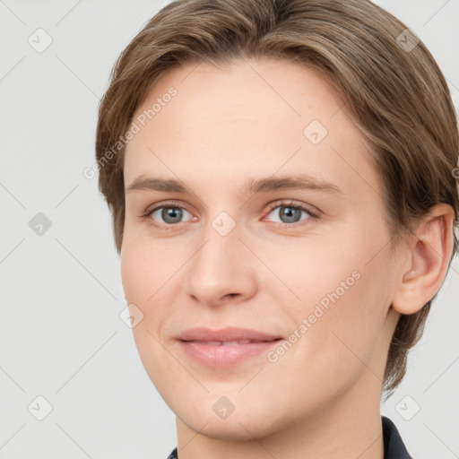 Joyful white young-adult female with short  brown hair and grey eyes