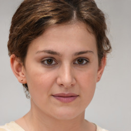 Joyful white young-adult female with medium  brown hair and green eyes