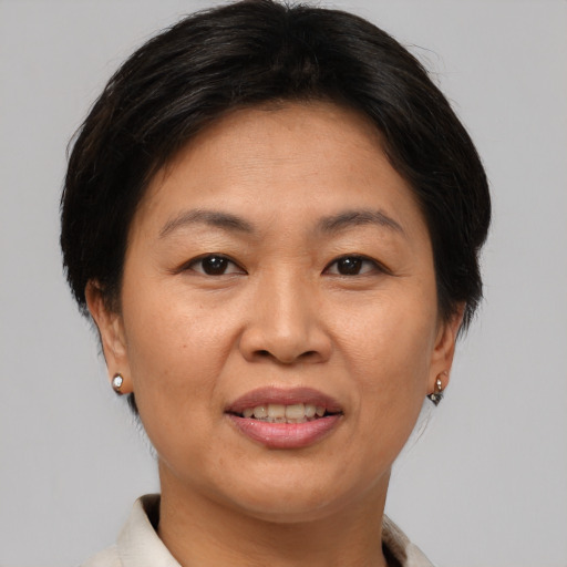 Joyful asian adult female with short  brown hair and brown eyes