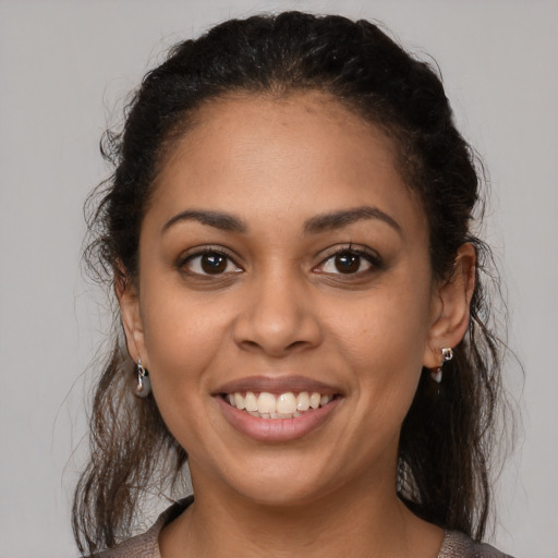 Joyful latino young-adult female with medium  brown hair and brown eyes