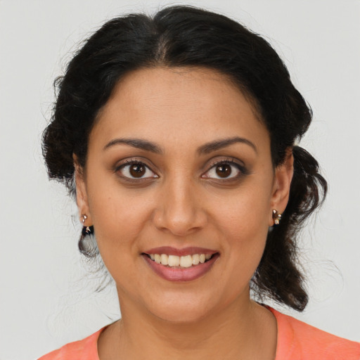Joyful latino young-adult female with medium  brown hair and brown eyes