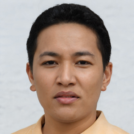 Joyful asian young-adult male with short  black hair and brown eyes