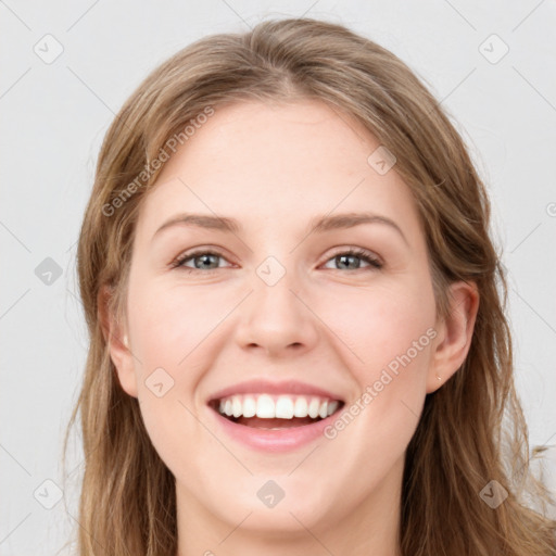 Joyful white young-adult female with long  brown hair and blue eyes