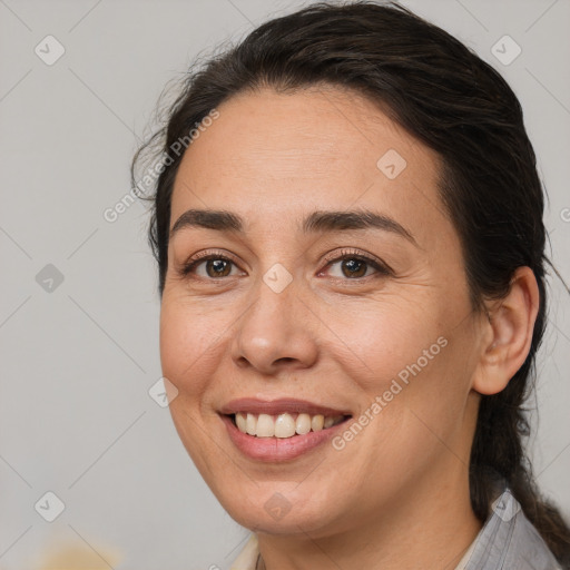 Joyful white adult female with medium  brown hair and brown eyes