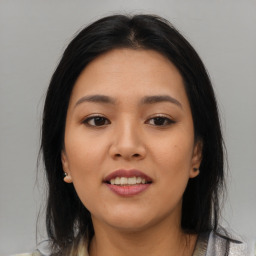 Joyful asian young-adult female with medium  black hair and brown eyes