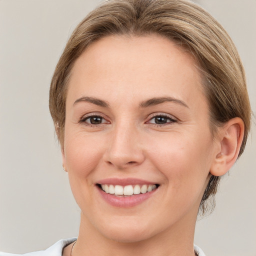 Joyful white young-adult female with medium  brown hair and brown eyes