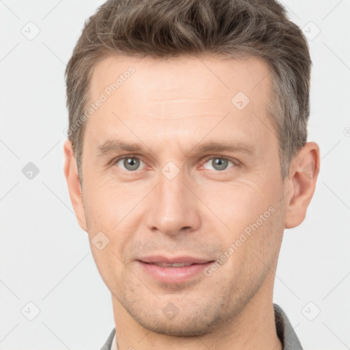 Joyful white adult male with short  brown hair and brown eyes