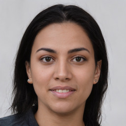 Joyful latino young-adult female with long  brown hair and brown eyes