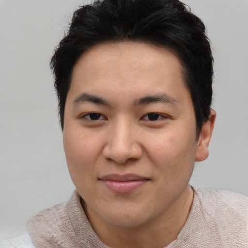 Joyful asian young-adult male with short  brown hair and brown eyes