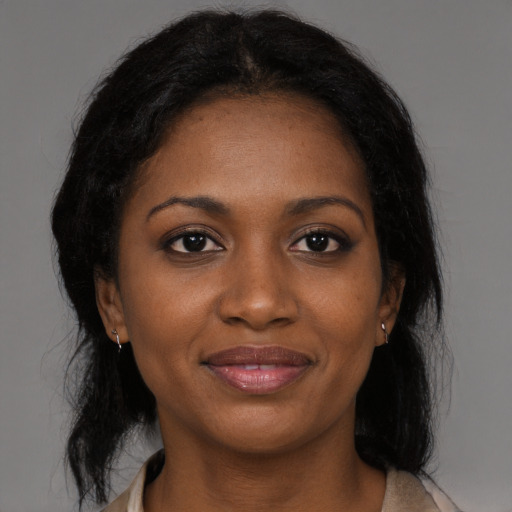 Joyful black young-adult female with medium  brown hair and brown eyes