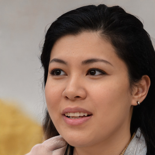 Joyful asian young-adult female with medium  brown hair and brown eyes