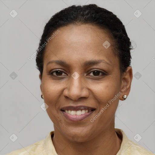 Joyful black adult female with short  black hair and brown eyes