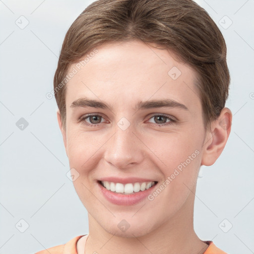 Joyful white young-adult female with short  brown hair and grey eyes