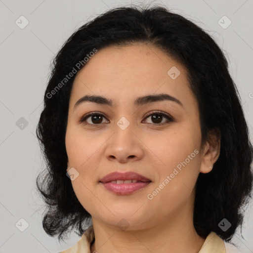 Joyful latino young-adult female with medium  brown hair and brown eyes