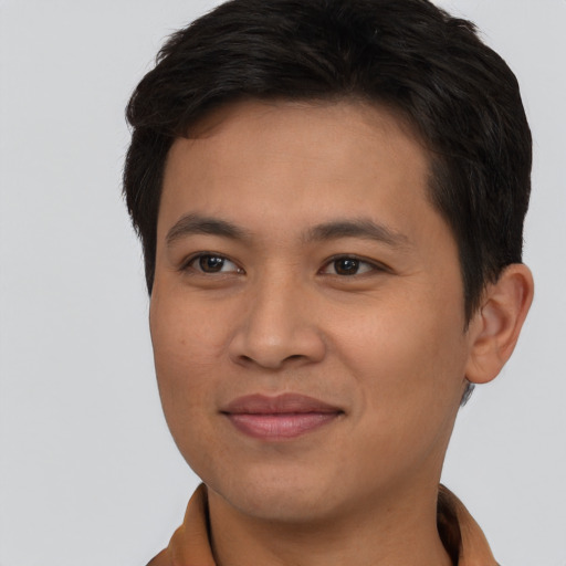 Joyful asian young-adult male with short  brown hair and brown eyes
