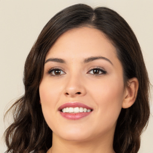 Joyful asian young-adult female with long  brown hair and brown eyes