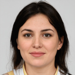 Joyful white young-adult female with medium  brown hair and brown eyes