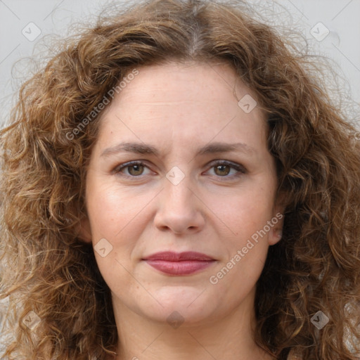 Joyful white adult female with long  brown hair and brown eyes