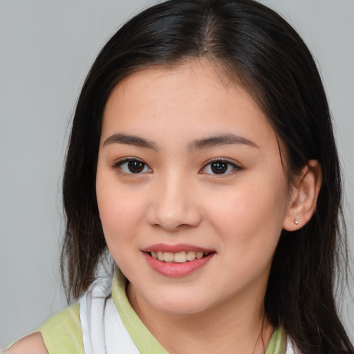 Joyful white young-adult female with long  brown hair and brown eyes