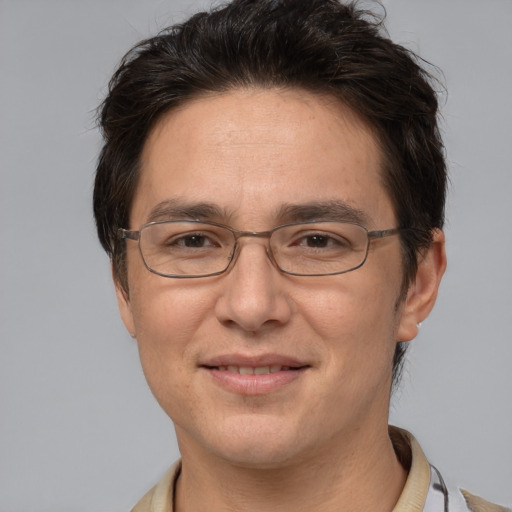 Joyful white adult male with short  brown hair and brown eyes