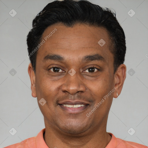 Joyful latino young-adult male with short  black hair and brown eyes