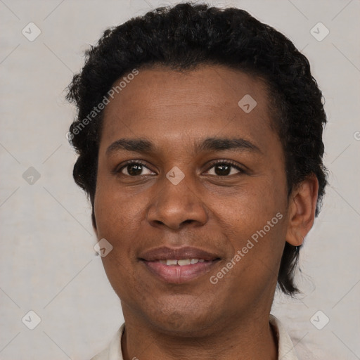 Joyful black young-adult male with short  brown hair and brown eyes