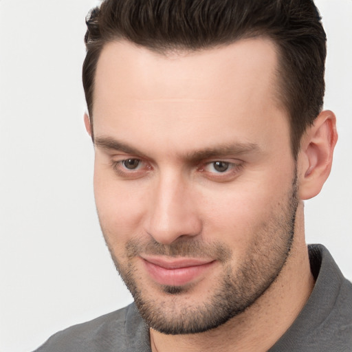 Joyful white young-adult male with short  brown hair and brown eyes