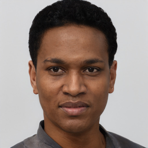 Joyful black young-adult male with short  black hair and brown eyes