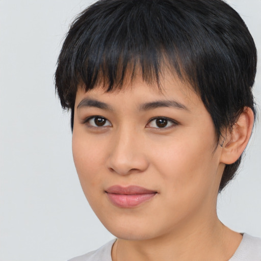 Joyful asian young-adult female with short  brown hair and brown eyes