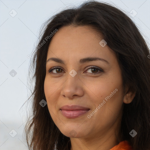 Joyful latino young-adult female with long  brown hair and brown eyes