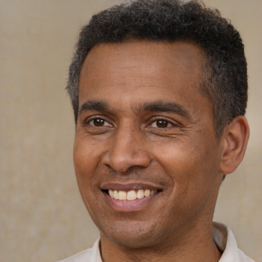 Joyful latino adult male with short  brown hair and brown eyes