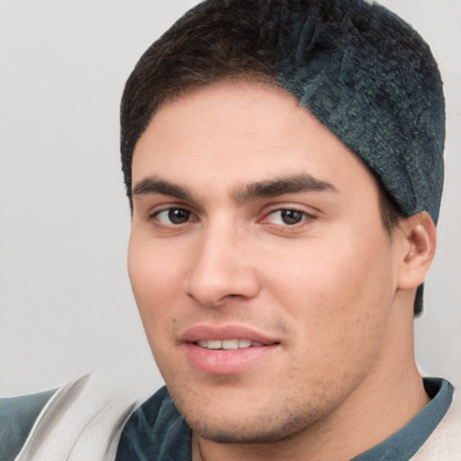 Joyful white young-adult male with short  black hair and brown eyes