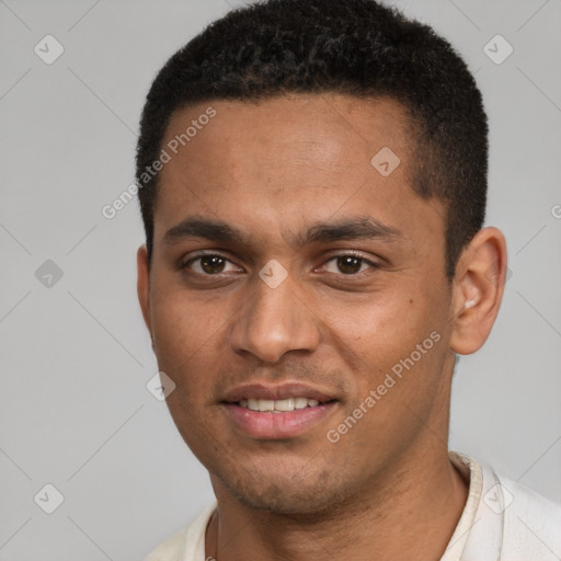 Joyful black young-adult male with short  brown hair and brown eyes