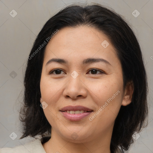 Joyful asian young-adult female with medium  brown hair and brown eyes