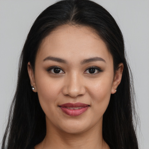Joyful white young-adult female with long  brown hair and brown eyes