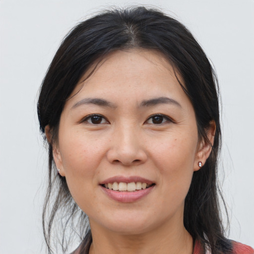 Joyful asian young-adult female with medium  brown hair and brown eyes