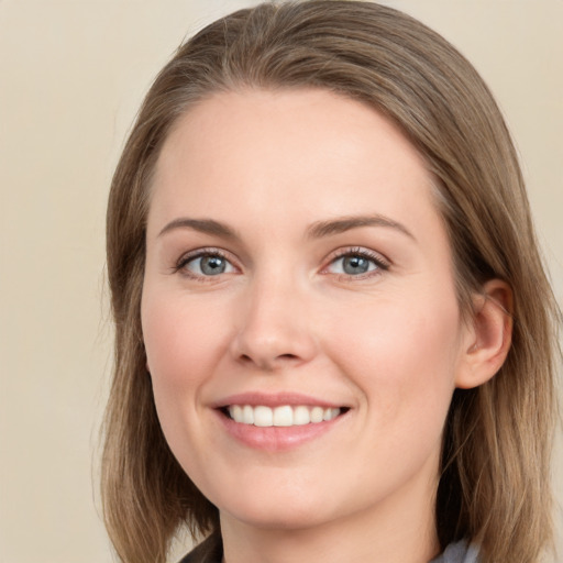 Joyful white young-adult female with long  brown hair and grey eyes