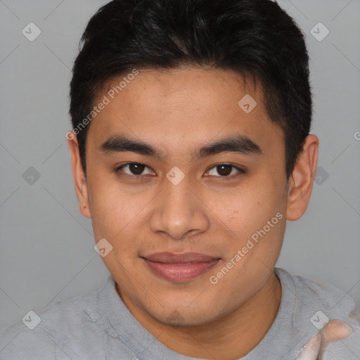 Joyful latino young-adult male with short  brown hair and brown eyes