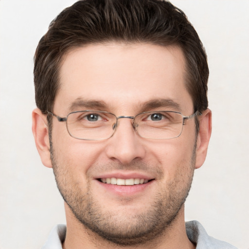 Joyful white adult male with short  brown hair and grey eyes