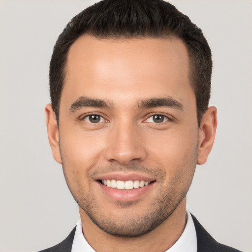 Joyful white young-adult male with short  brown hair and brown eyes