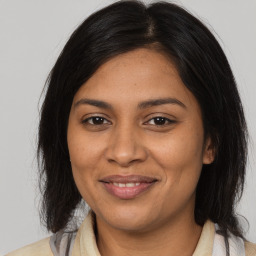 Joyful black young-adult female with medium  brown hair and brown eyes